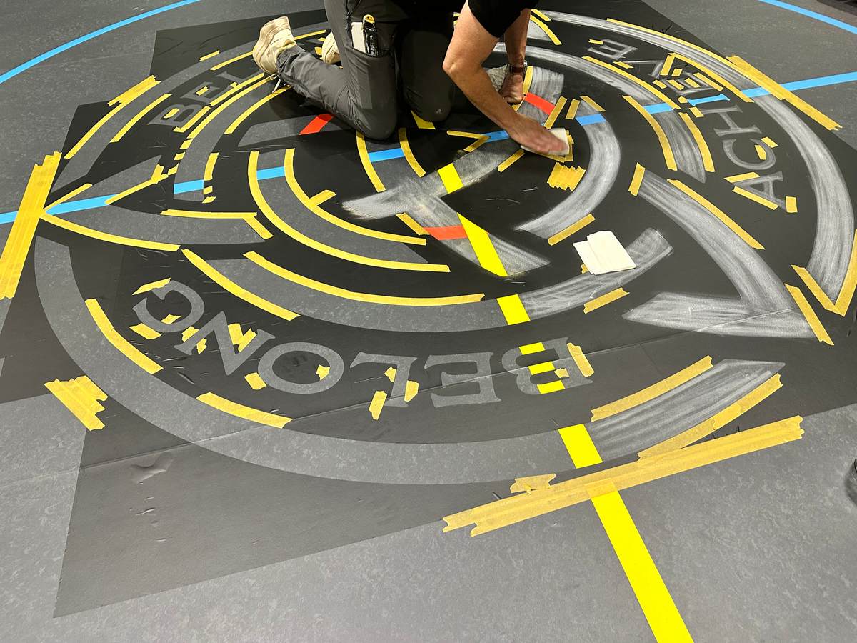 Masking out a school crest before painting