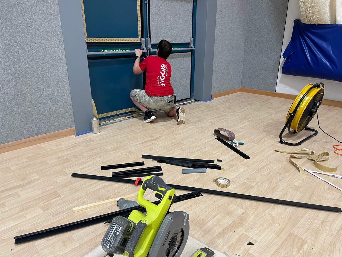 Fitting Softwall panels around a sports hall fire door