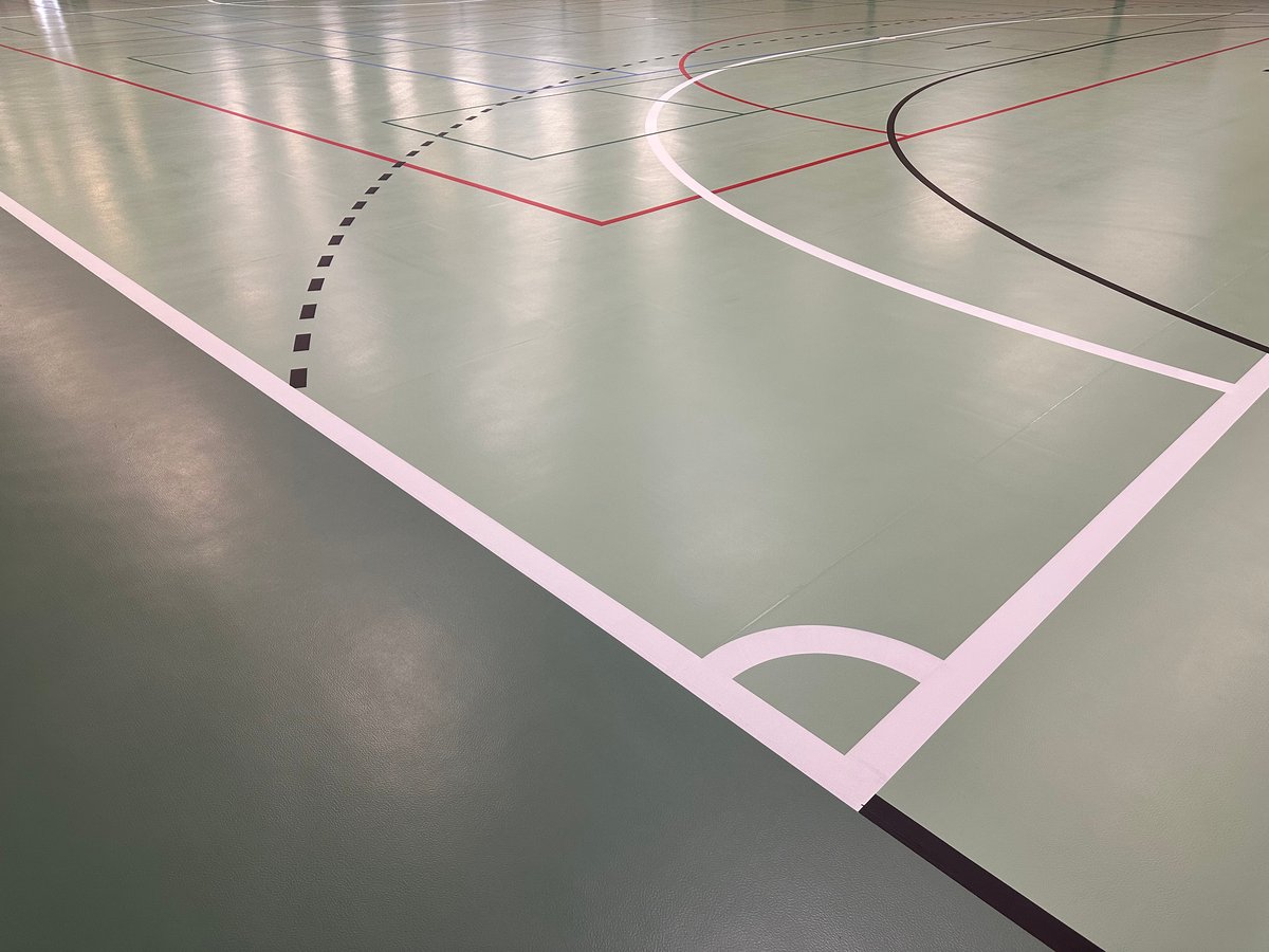 Fresh court markings on a green sports floor