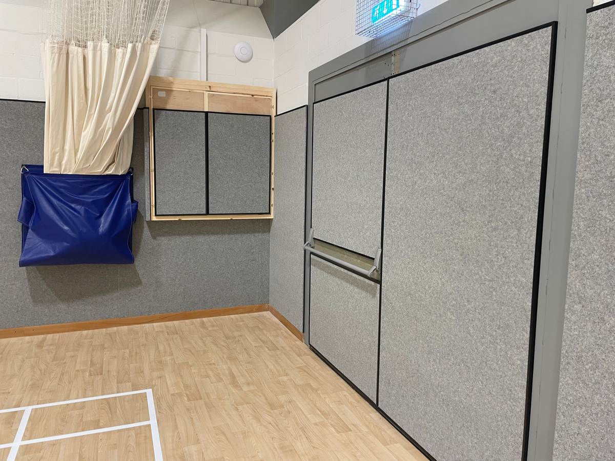Grey Softwall anti-shock panels lining a sports hall