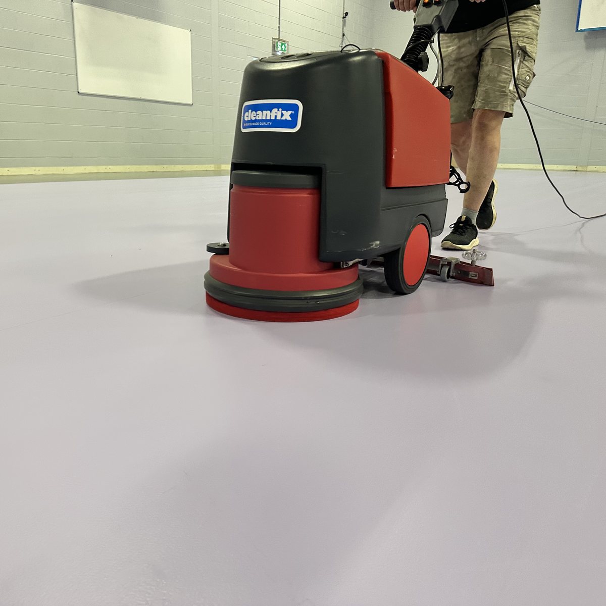 Cleaning the new Taraflex floor with a Cleanfix scrubber dryer before marking