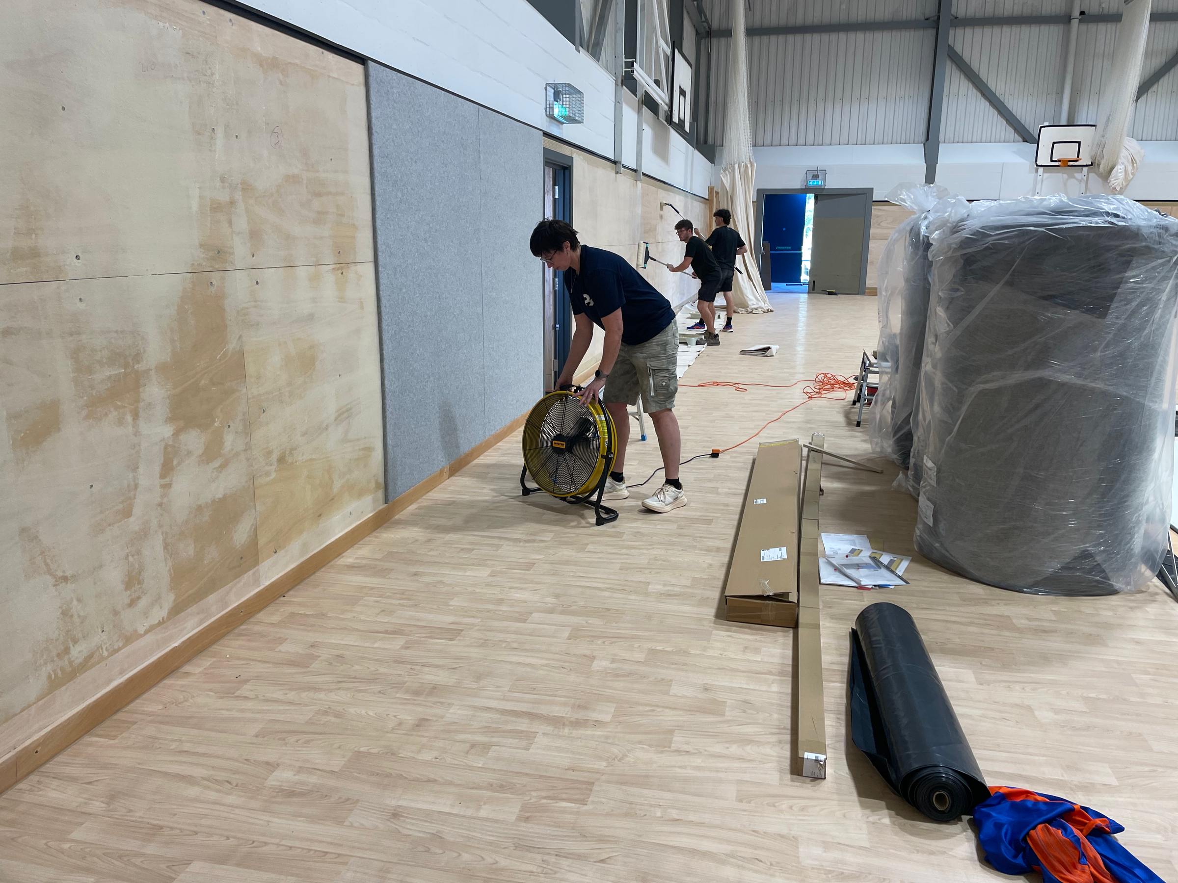 Lining sports hall walls with plywood before fitting Softwall